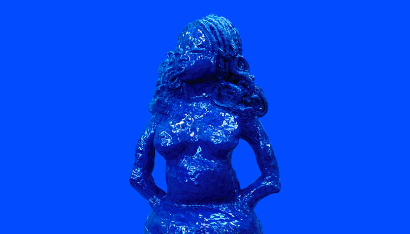 A photo of a sculpture of a woman with curly hair which is painted blue.