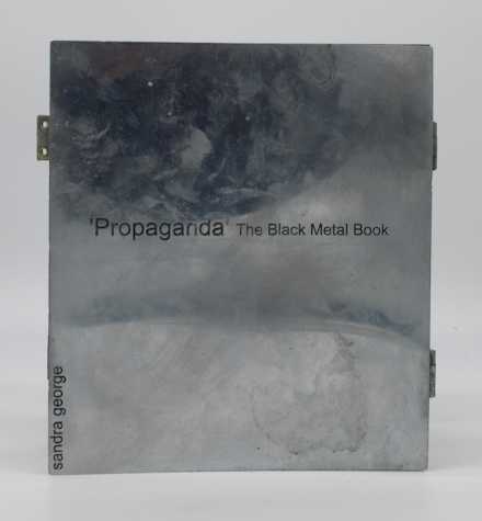 image of a book titled 'propaganda' the black metal book. on the left edge of the book it reads Sandra George.
